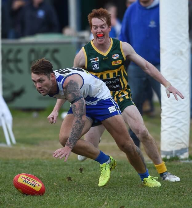 DOWN LOW: Yackandandah key forward Trent Castles keeps the football out in front of Tallangatta's Joseph Forrest on Saturday. Pictures: MARK JESSER