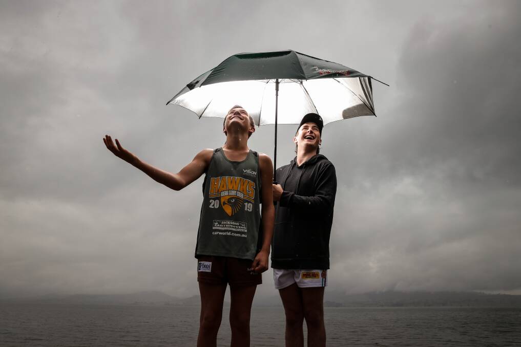 RAIN RAIN STAY AWAY: James, 16 and Leon Furze, 17, braved the wet conditions on Tuesday to prepare for the Kiewa-Tangambalanga Milk Run at Huon Reserve on Sunday. Picture: JAMES WILTSHIRE