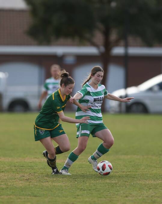WORK TO BE DONE: Albury United's Allanah Seary is closed down by St Pats' midfielder Claire Mahoney. The league leaders will look to maintain their buffer on top against Wangaratta on Sunday. Picture: TARA TREWHELLA