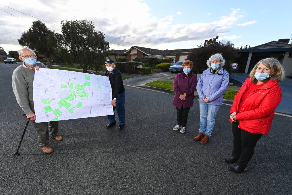 Pictured in 2020, Allambie Crescent residents Bill Pinder, Bill Nicholls, Gloria Newton, Glenda Fogarty and Heather Watts with a map highlighting homes where there have been cancer diagnoses. Picture by Mark Jesser