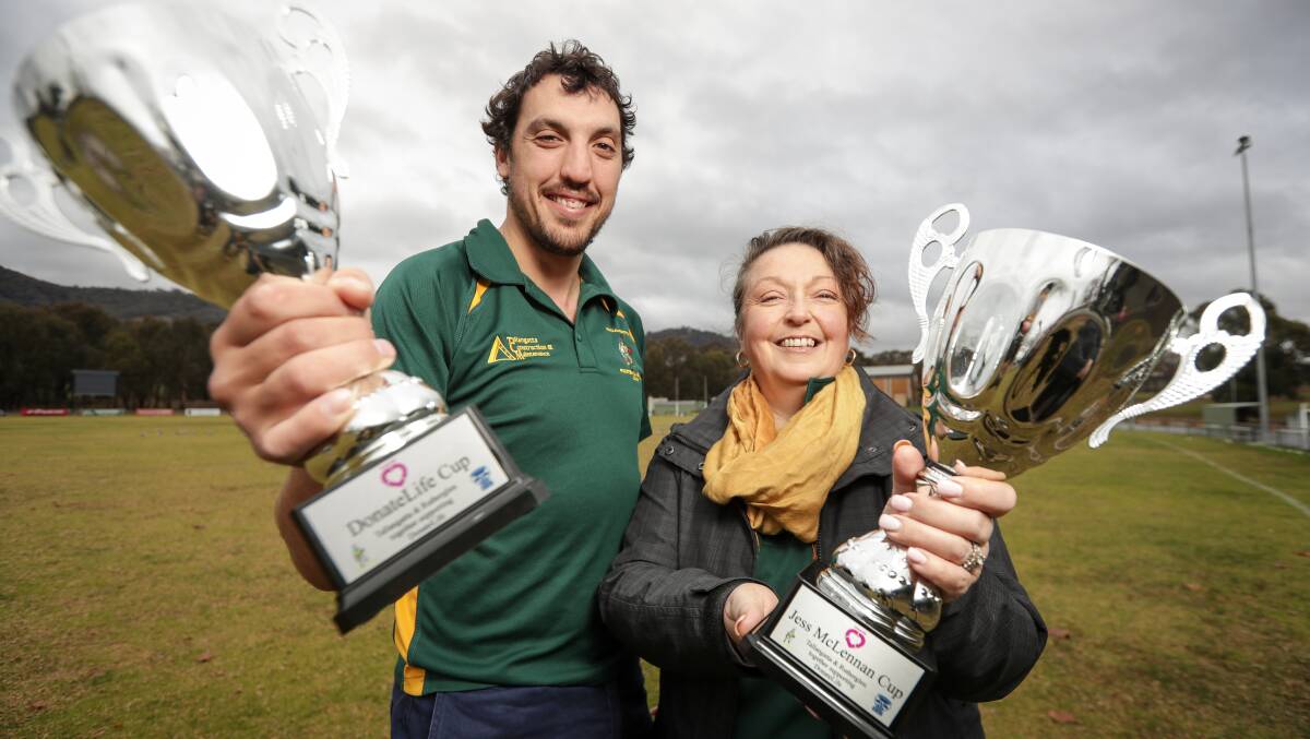 Tallangatta coach Sam Livingstone and club volunteer Sharlene De Amyand with the Donate Life and Jess McLennan Cups. Picture: JAMES WILTSHIRE