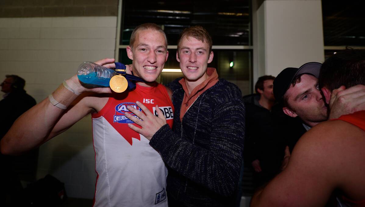 Sam Reid celebrates with brother, Ben, after his 2012 AFL grand final win with Sydney.