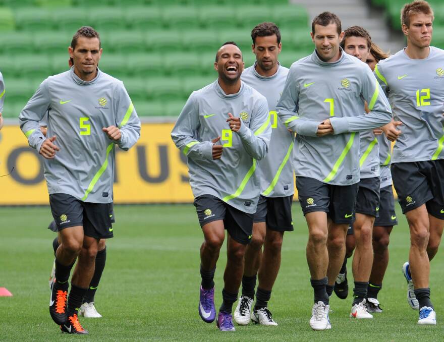 GREEN AND GOLD: Jade North, Archie Thompson and Brett Emerton at a Socceroos training session in Melbourne in 2012. Picture: VINCE CALIGIURI
