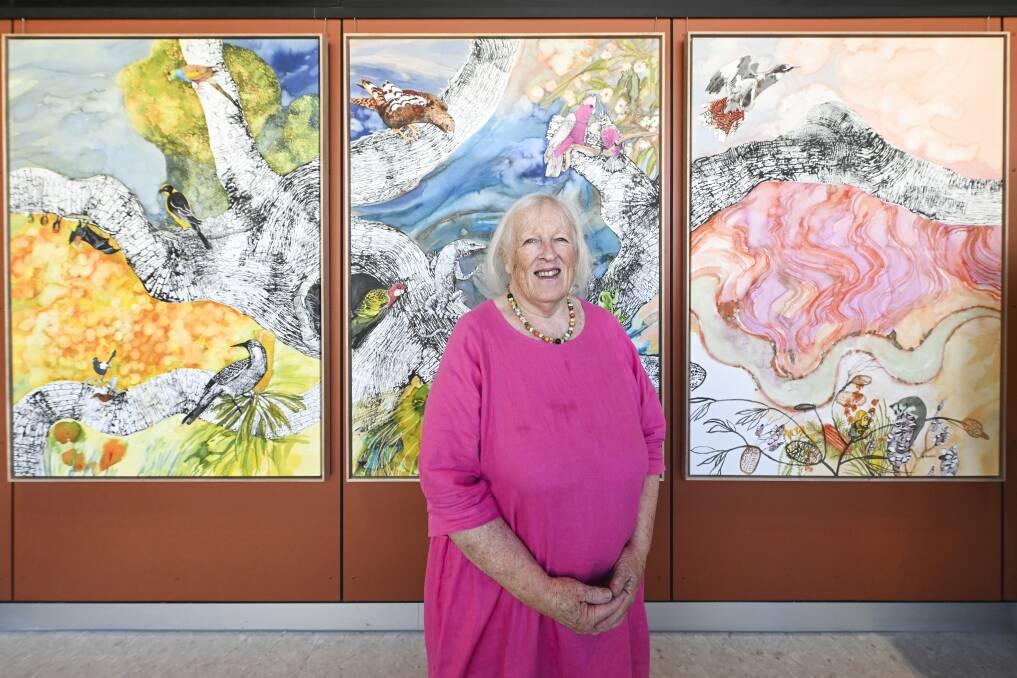 Abi Thompson in front of her watercolour piece, Murray Meander, displayed in the main waiting room of the new Albury hospital emergency department. Picture by Mark Jesser