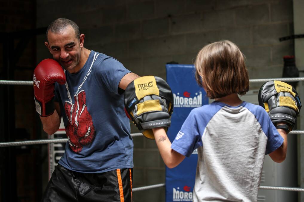 PACKING A PUNCH: Sam Soliman teamed up with Conor Friswell, 8, during his visit to Border Boxing Club on Sunday. Picture: JAMES WILTSHIRE