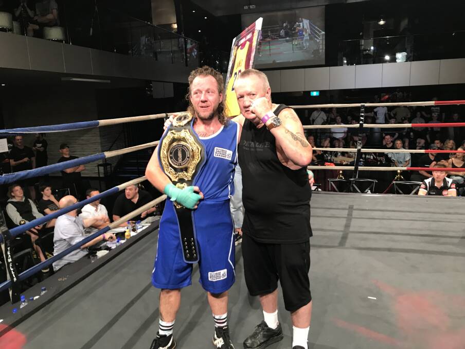 CHAMPION: Albury boxer Tony Kennedy celebrates his very first state title with trainer John Frawley after taking out the Victorian amateur cruiserweight crown.
