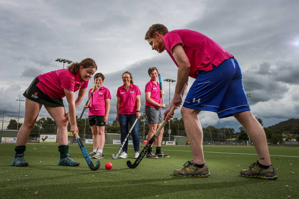 GAME ON: Halle and Danny Hicks (front) with Alistair, Jo, and Oliver Peachey, ahead of the start of twilight hockey competition at Albury Hockey Centre. Picture: JAMES WILTSHIRE