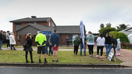 SIGNIFICANT INTEREST: A strong crowd gathers to catch a glimpse of the auction at 30 Barton Street in Wodonga on Saturday morning. The property was passed in but sold shortly afterwards for $760,000. Pictures: MARK JESSER