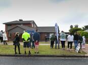SIGNIFICANT INTEREST: A strong crowd gathers to catch a glimpse of the auction at 30 Barton Street in Wodonga on Saturday morning. The property was passed in but sold shortly afterwards for $760,000. Pictures: MARK JESSER