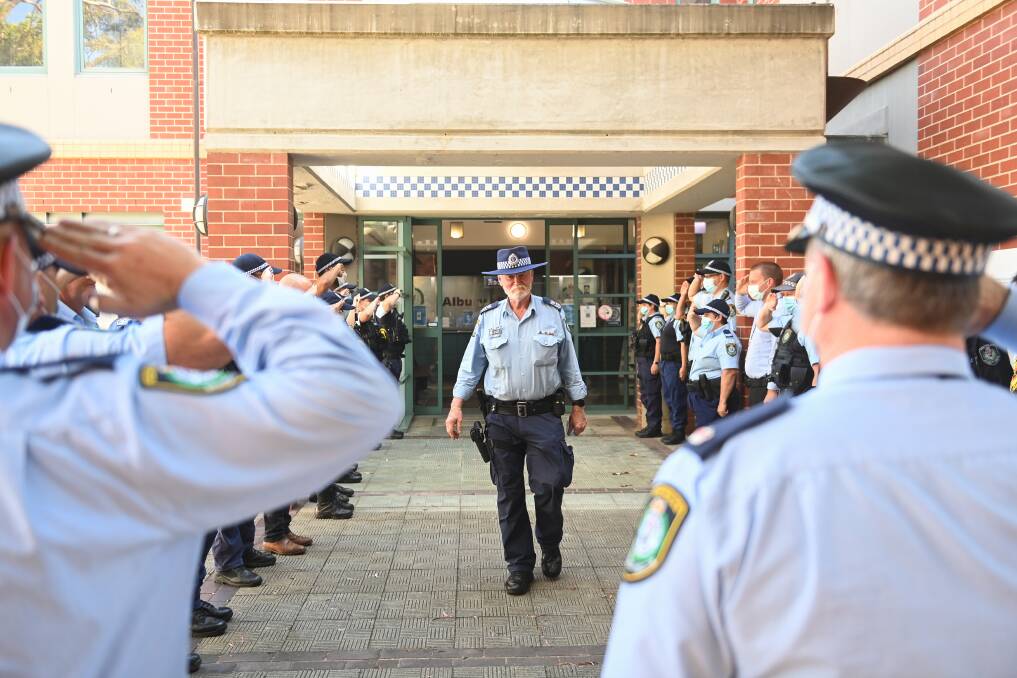 WE SALUTE YOU: Senior Sergeant Les Nugent is given a guard of honour by his colleagues at the end of his last day in the police force after more than 50 years of service, 25 of which were in Albury. Picture: MARK JESSER
