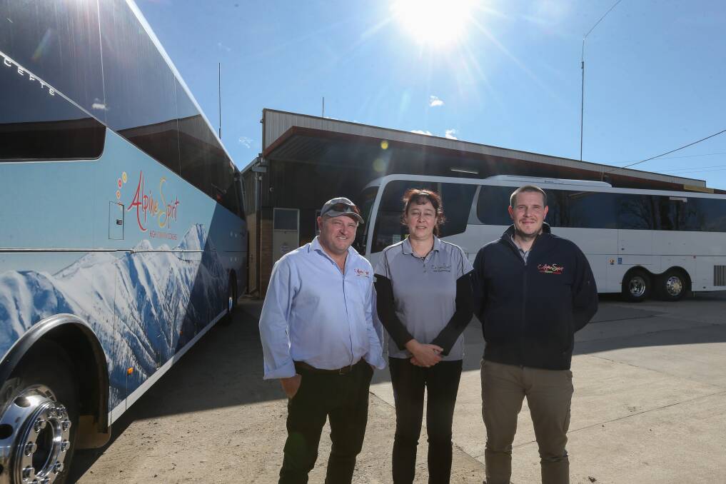 STANDSTILL: Alpine Spirit Coaches owner Chris Bonacci with wife, Nadina, and operations manager Grainge Phillips at the Myrtleford depot. Picture: TARA TREWHELLA