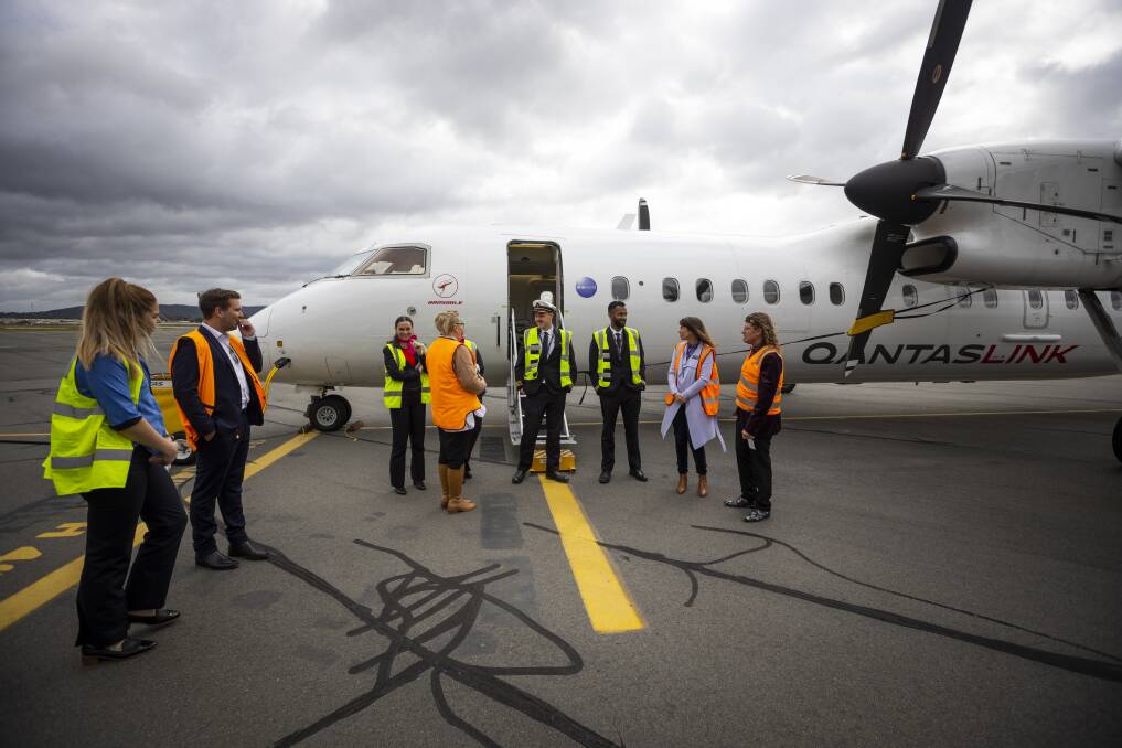 Albury mayor and deputy mayor Kylie King and Steve Bowen talk with Qantas crew members after the first flight to the Border city from Adelaide landed in July. Picture by Ash Smith
