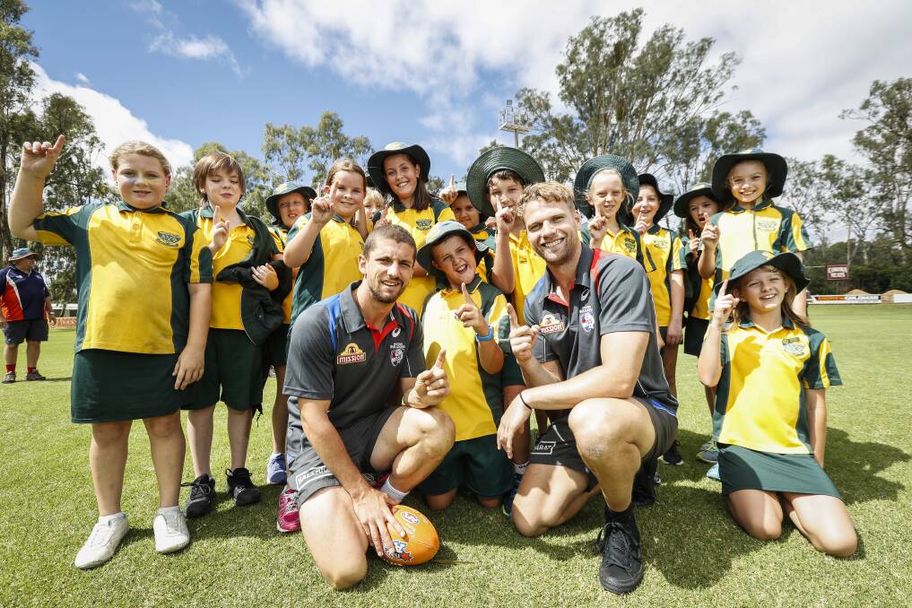 STAR POWER: Tom Liberatore and Jake Stringer with students from Corowa South
Public School during the Western Bulldogs' AFL Community Camp in Corowa on Monday.
Picture: JAMES WILTSHIRE