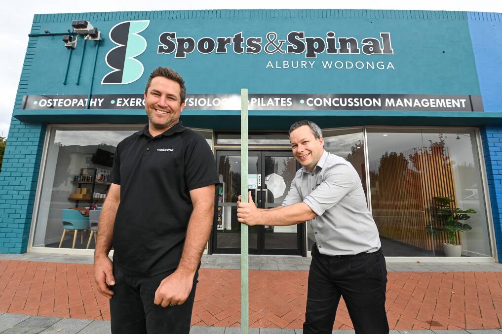 NOTICEABLE DIFFERENCE: McKeone Constructions' Tim Price is measured up by Sports and Spinal Albury Wodonga director Vaughan Saunders outside the redeveloped commercial space on South Street. Picture: MARK JESSER