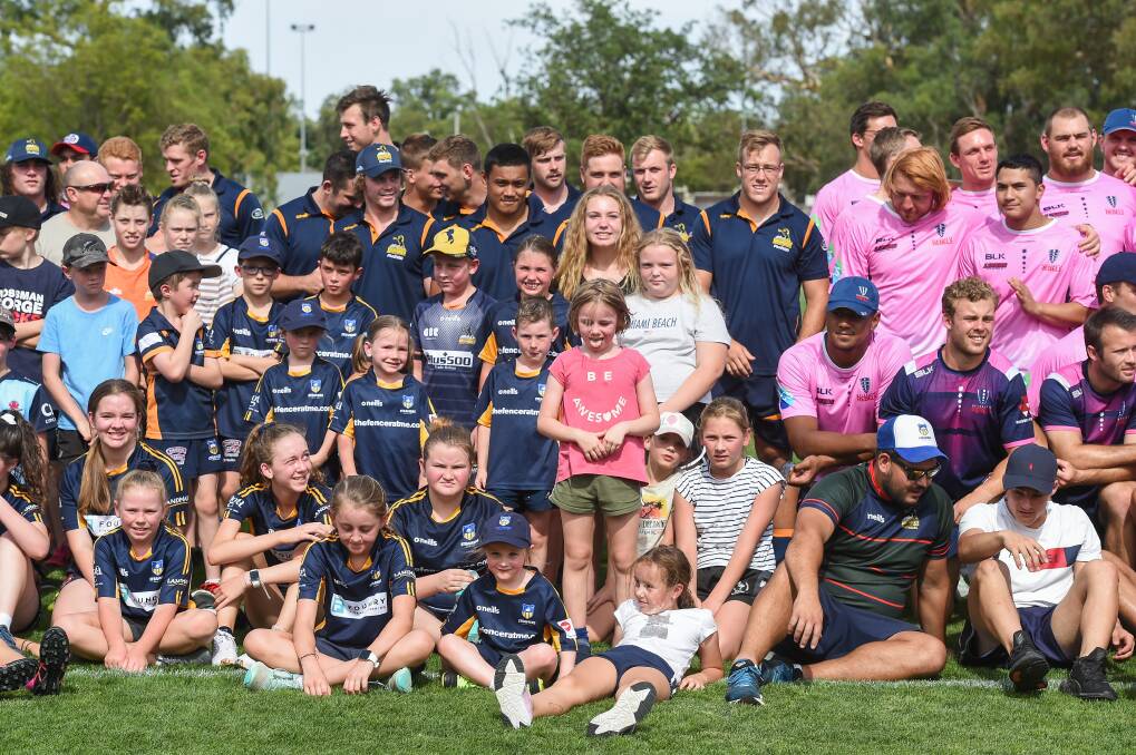 WE'RE ALL IN: Albury-Wodonga Steamers juniors enjoyed spending the afternoon with ACT Brumbies and Melbourne Rebels stars at Greenfield Park on Wednesday in readiness for Thursday's Super Rugby trial. 