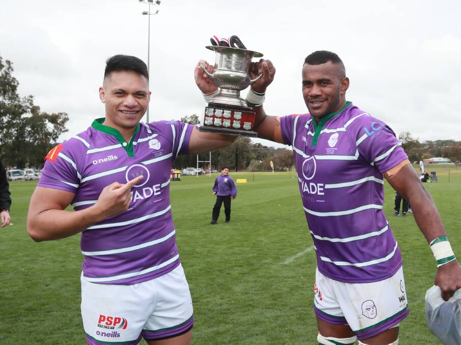 WELL PLAYED: Leeton captain Paul Ta'avao and Seremaia Jerry Navia hold the trophy aloft after the Phantoms captured the SIRU second grade premiership on Saturday.