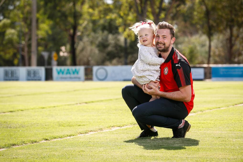 WHAT A JOURNEY: Murray United captain Ashley Dunn, with daughter, Milla Rose, 2, will play his 100th game for the club on Saturday. Picture: JAMES WILTSHIRE