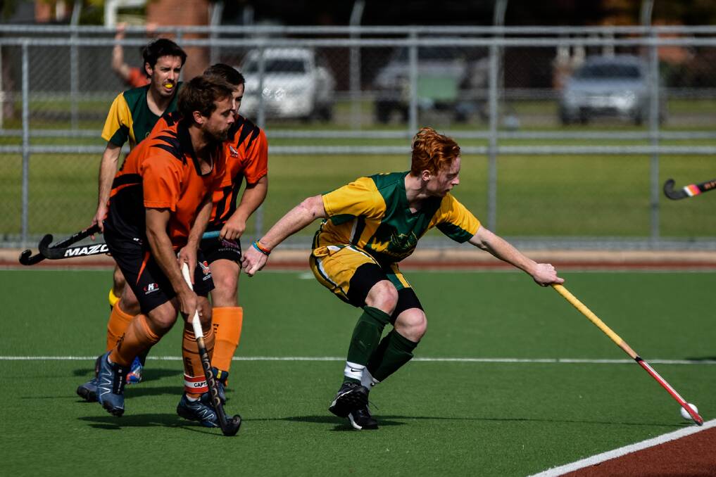 LONG REACH: Wombats' Andrew Nixon controls the ball against Falcons.