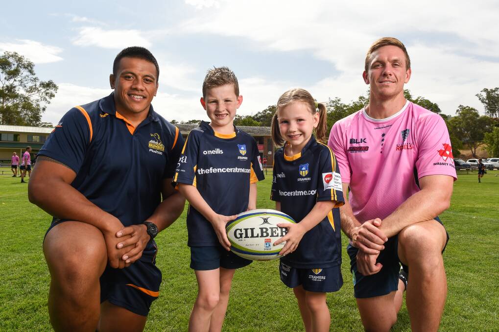 SUPER CLASH: ACT Brumbies captain Allan Alaalatoa and Rebels skipper Dane
Haylett-Petty with Georgia, 6, and Lachlan Zemaitis, 7, of Albury at Greenfield Park.
Pictures: MARK JESSER