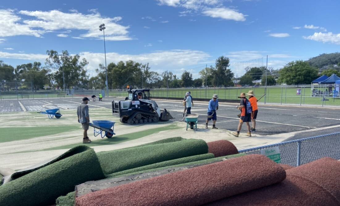 BIG EFFORT: Several hours of volunteer labor was required to remove the playing surface of Albury Hockey Centre's main pitch in preparation for new turf to be laid. It's been more than 10 years since it has been replaced.