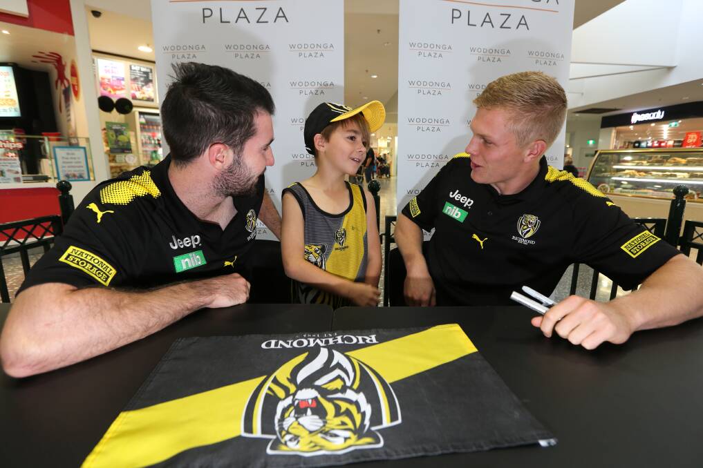 PURE JOY: Lavington's Anthony Thomas, 9, waited in line for more than an hour to catch up with Richmond young guns Corey Ellis and Ryan Garthwaite on Tuesday. Picture: KYLIE ESLER