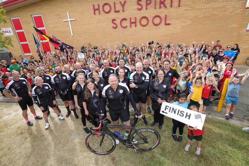 GREAT SCENES: Lavington's Holy Spirit School principal Matt Kean with his students and supporters after completing the Melanoma Ride on Thursday. Picture: JAMES WILTSHIRE