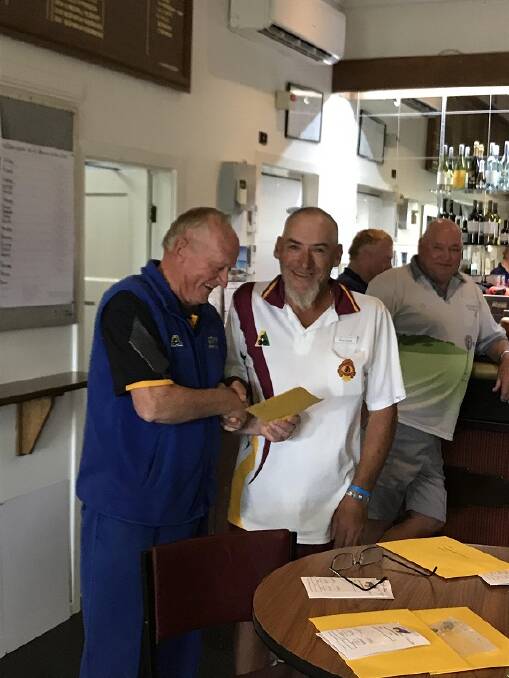 NICELY PLAYED: Oaklands bowler Ron Bonat is congratulated by Zone 8 vice-president Dennis Melmoth after winning the president's reserve singles at Ariah Park.