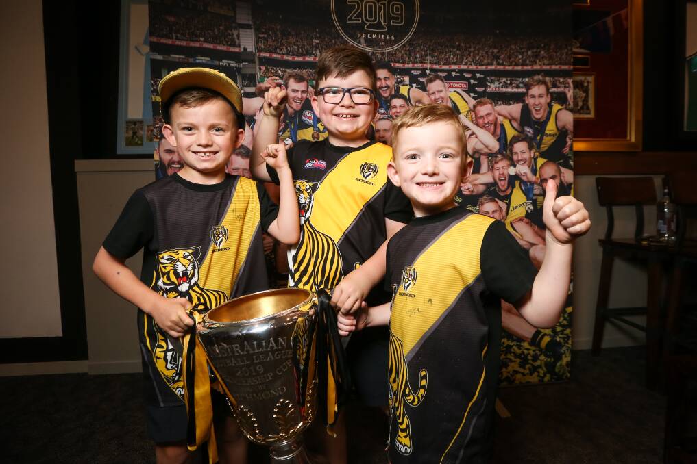 TIGER TRIO: Wodonga's Judd, 7, Jack, 8 and Clay, 5, O'Loughlin with the AFL premiership cup in Albury on Wednesday. Picture: JAMES WILTSHIRE