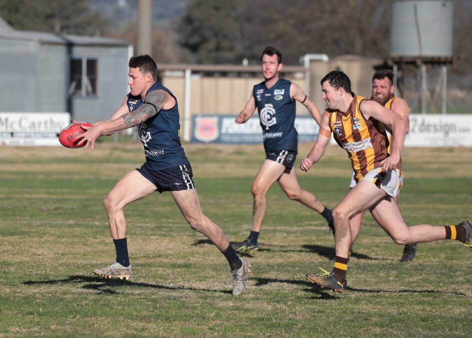 GOING UP: Brad Whinray sends Greta forward in its victory against North Wangaratta on Saturday, which saw the Blues move into the top six. Picture: WANGARATTA CHRONICLE
