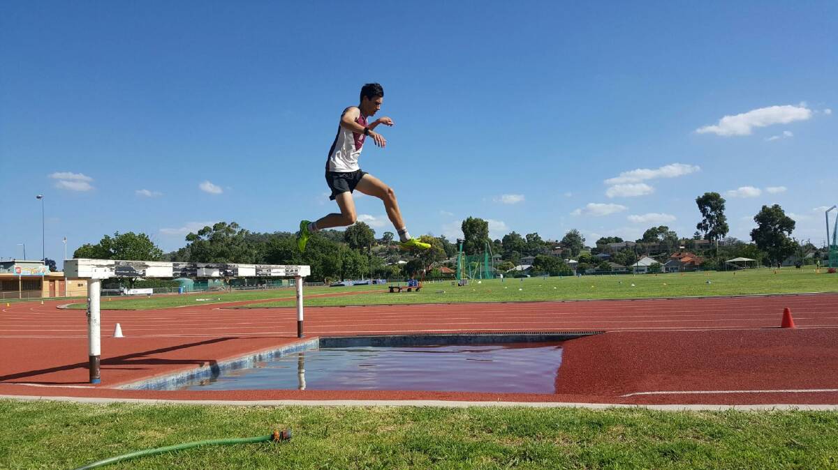 GIANT LEAP: Wodonga Athletics Club's Ryan Blackwell takes off during the recent steeplechase at Albury's Alexndra Park.