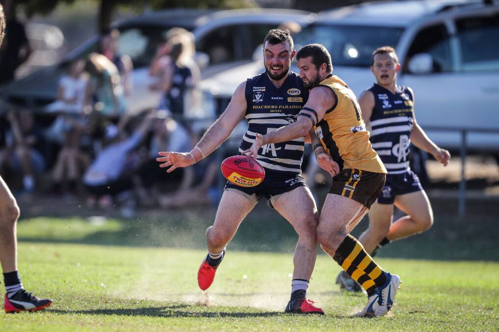 UNDER THE PUMP: Rutherglen's Josh Warren gets a kick away during the Cats' clash with Kiewa-Sandy Creek earlier this season. Picture: JAMES WILTSHIRE