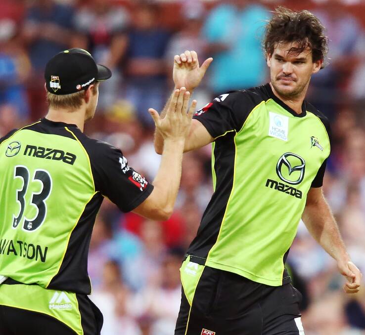 DANGER MAN: Sydney Thunder's Clint McKay celebrates one of his 18 wickets with Shane Watson during the BBL last season. Picture: GETTY IMAGES