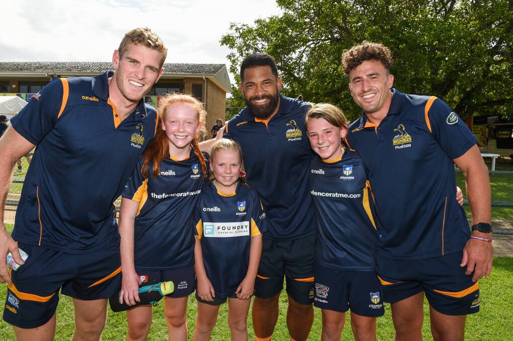 ALL SMILES: ACT Brumbies players Tom Cusack, Scott Sio and Tom Banks with Albury's Liz Wantling, 14, Alice Bell, 10, and Rose Bell, 11, at Greenfield Park.