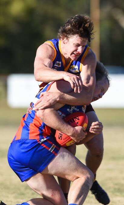 HARD NOSED: Wahgunyah's Dean Skinner takes a hit to the nose during this tackle on Beechworth's Brayden Carey last weekend. Picture: MARK JESSER