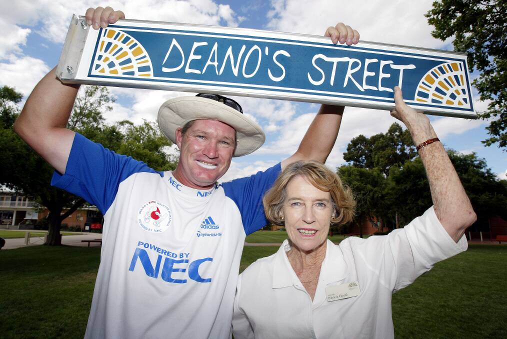 WELCOME TO TOWN: Jones holds his specially made Deano's Street sign with former Albury mayor Patricia Gould upon his arrival to town in 2003.