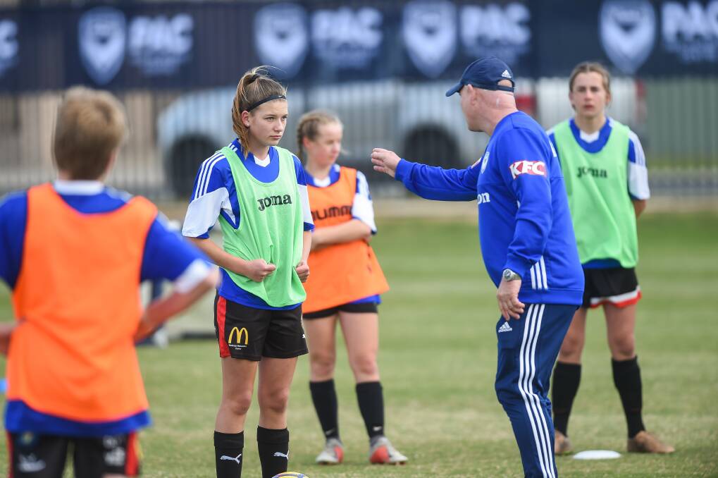 IN THE ZONE: Sophie Cary of Thurgoona gets some tips from Melbourne Victory under-21 head coach Gareth Naven. Picture: MARK JESSER.