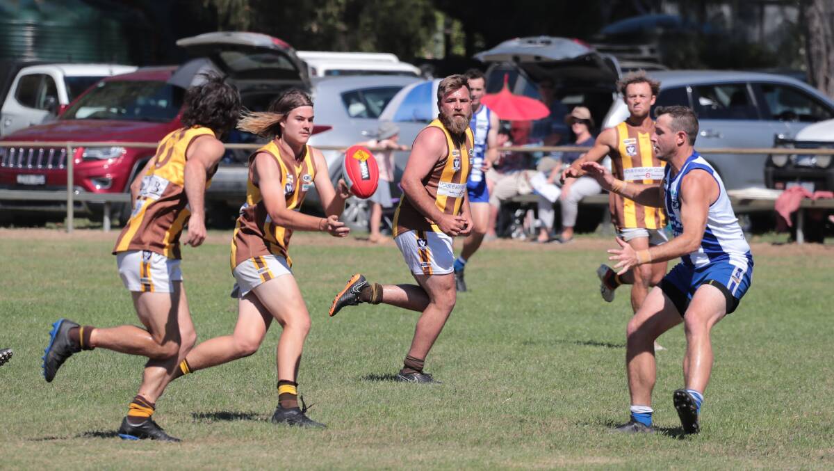 QUICK HANDS: North Wangaratta's Cooper Matheson-Grey fires off a handball against King Vallley in round two of the Ovens and King season. Picture: WANGARATTA CHRONICLE