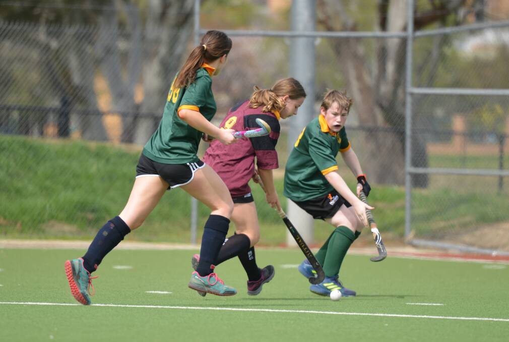 ON THE MOVE: Stella Moeliker looks to push past Seth Russell on an attack towards the circle in Hockey Albury-Wodonga's junior eights competition. Picture: NARELLE HAMILTON