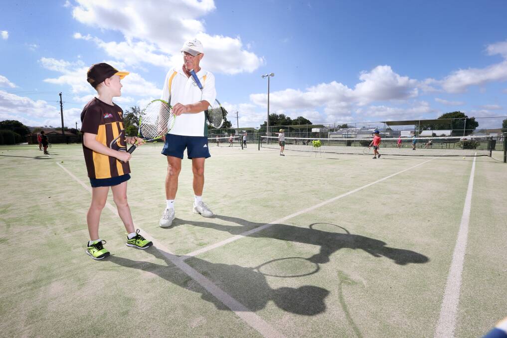 VALUABLE LESSON: Albury's Harrison Way, 8, working with Albury Tennis Association mentor Ken Wurtz. The junior coaching program continues at the Albury Grasscourts on Saturday. Picture: KYLIE ESLER