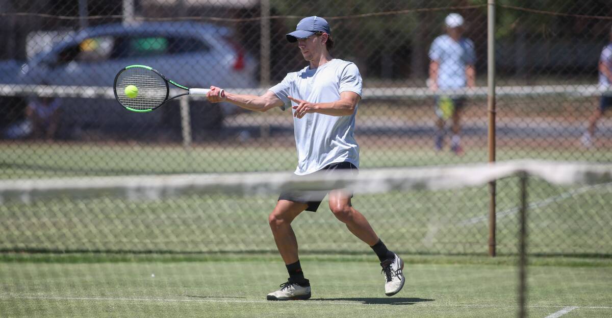 WHACK: Daniel Smith is aggressive with this forehand during day one of the Victorian Junior Grasscourt Championships. Pictures: TARA TREWHELLA