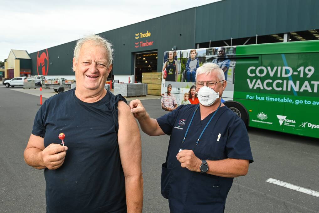 JAB DONE: Wodonga builder Laelan Knight with nurse immuniser Clint Sutton after his COVID-19 booster at Bunnings Warehouse on Wednesday. Picture: MARK JESSER