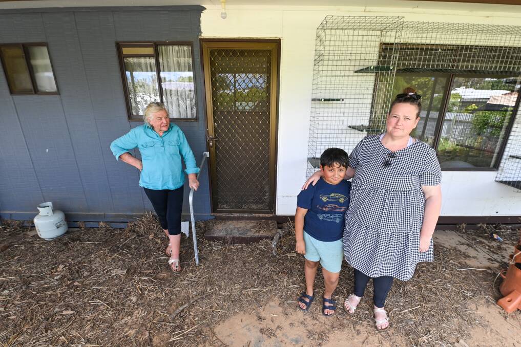 GUTTED: Kerry Anstee, her daughter, Nicole, and grandson Alex Kidd-Alam, 8, visit their Main Street home two months after major flooding activity at Rutherglen. Nicole described the yard as a "war zone" with fences dismantled and debris washed in from across the town. Pictures: MARK JESSER