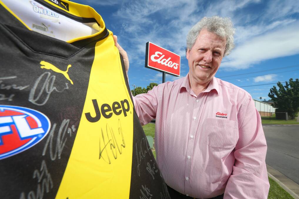 VICTORY: Michael Middleton, of Elders Insurance, took out The Border Mail AFL tipping competition and won a signed Richmond guernsey. Picture: JAMES WILTSHIRE