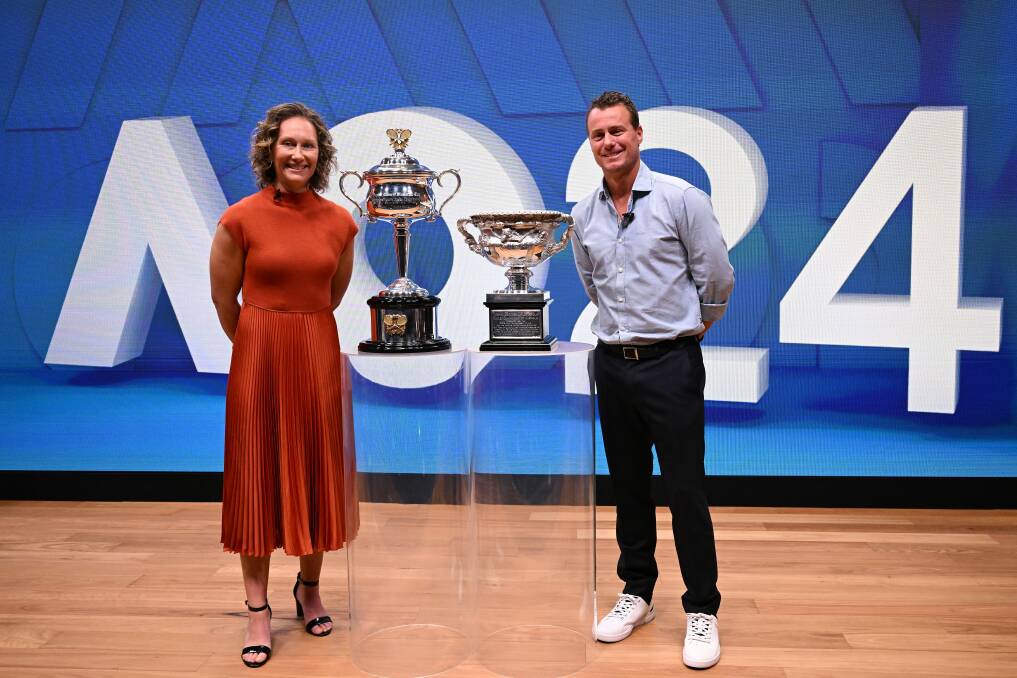 Sam Stosur and Lleyton Hewitt with the Australian Open men's and women's singles trophies at the launch of the 2024 tournament in October. Picture by AAP