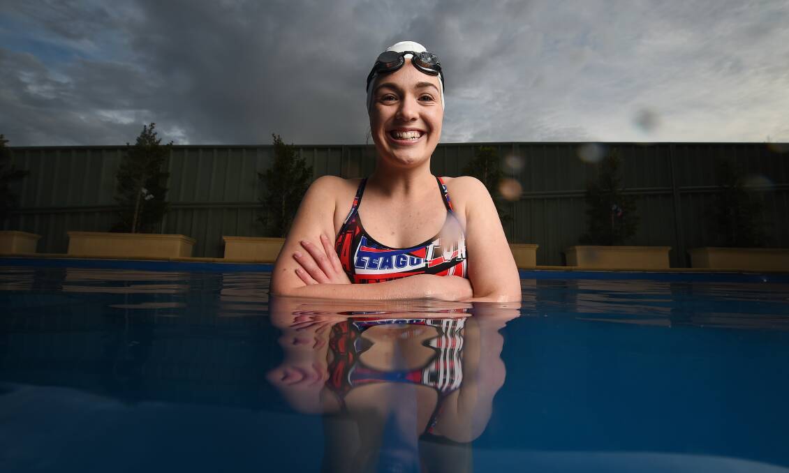 ALL SMILES: Mikaela Clemson braved the cold in her backyard swimming pool one last time before she jets off to the US. Picture: MARK JESSER