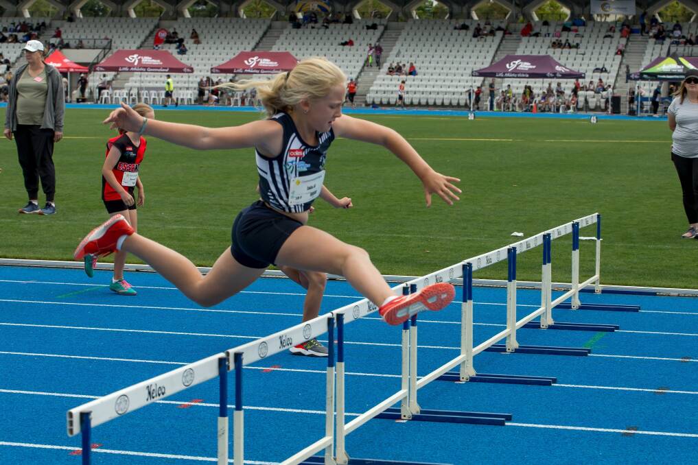 COMMITMENT: Albury's Isla Geddes in full stride in her hurdles event at the Little Athletics Victoria State Combined Event Championships in Melbourne on the weekend. Picture: ANTHEA ENGLISH