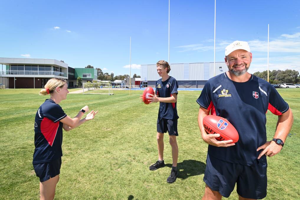 SCHOOL AND SKILLS: Murray Bushrangers players Keeley Skepper and Josh Tweedale have enjoyed the chance to train at school with Cathedral College Wangaratta academy coordinator Dale Carmody. Picture: MARK JESSER