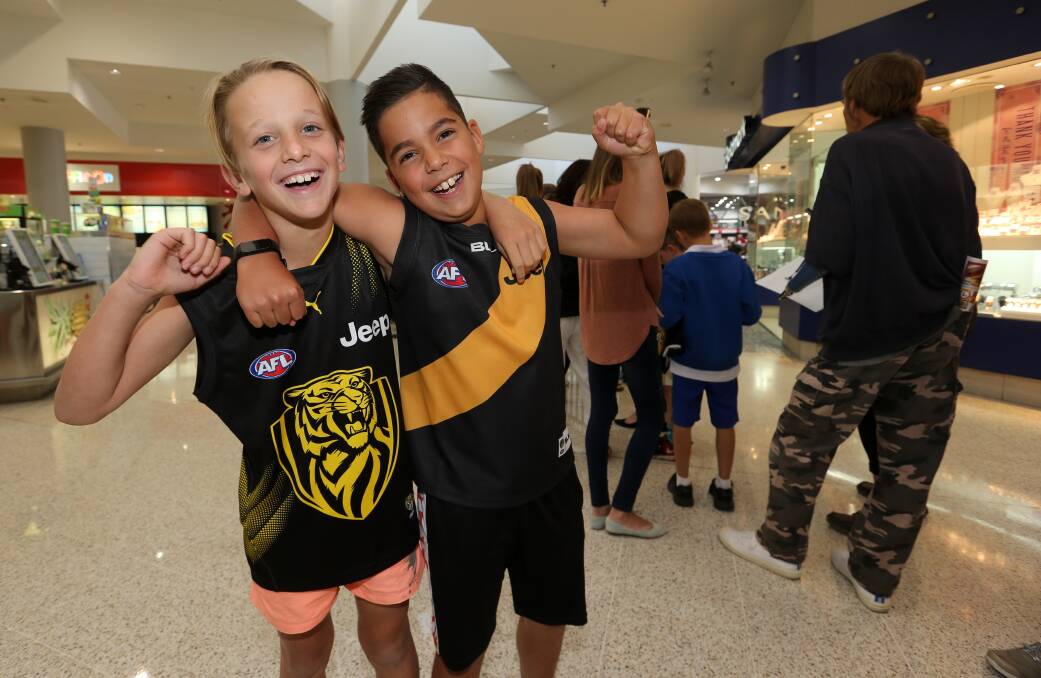 HAPPY CAMPERS: Jay McInnes, 9, from Thurgoona and friend Koby Murray, 9, from Lavington, were getting excited while waiting in line to catch up with Richmond's Ryan Garthwaite and Cory Ellis. Picture: KYLIE ESLER