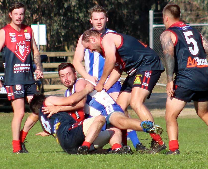 WRAPPED UP: Tumbarumba's Jordan Dennis is tackled by Corryong's Jayden Downs and Thomas Nicholas at Corryong Recreation Reserve on Saturday. Picture: DEB HARRAP