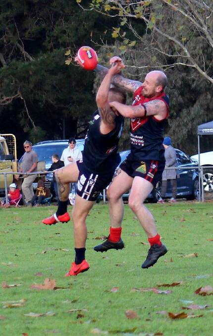 STRONG CONTEST: Corryong's Jesse Crawford denies Cudgewa forward Ben Hall with a superb spoil during Saturday's clash. Pictures: DEB HARRAP
